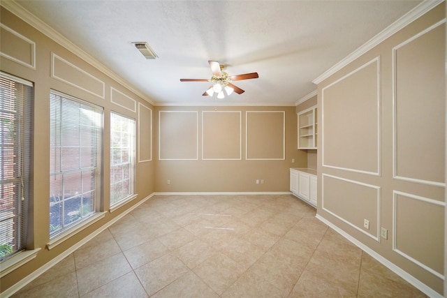 unfurnished room featuring crown molding, a decorative wall, a ceiling fan, and visible vents