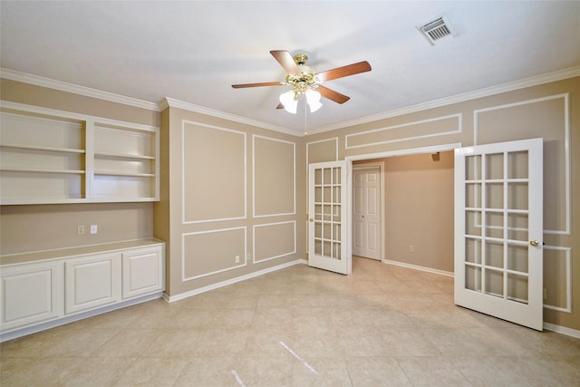 unfurnished room with a decorative wall, french doors, crown molding, and visible vents