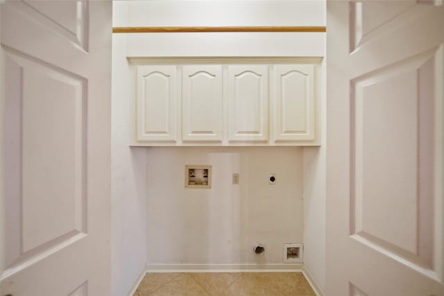 washroom featuring light tile patterned floors, baseboards, hookup for an electric dryer, cabinet space, and washer hookup