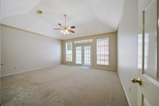 carpeted spare room with lofted ceiling, baseboards, visible vents, and ornamental molding