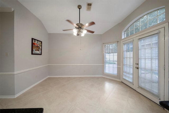 spare room with light tile patterned floors, baseboards, visible vents, vaulted ceiling, and french doors