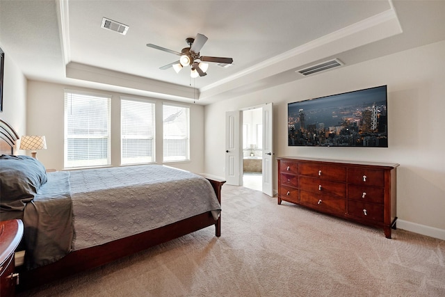 bedroom featuring visible vents, a raised ceiling, light colored carpet, and baseboards