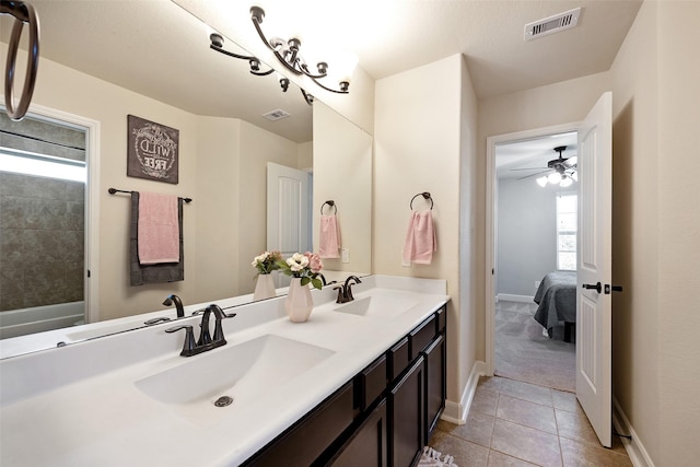 bathroom featuring tile patterned flooring, double vanity, visible vents, and a sink