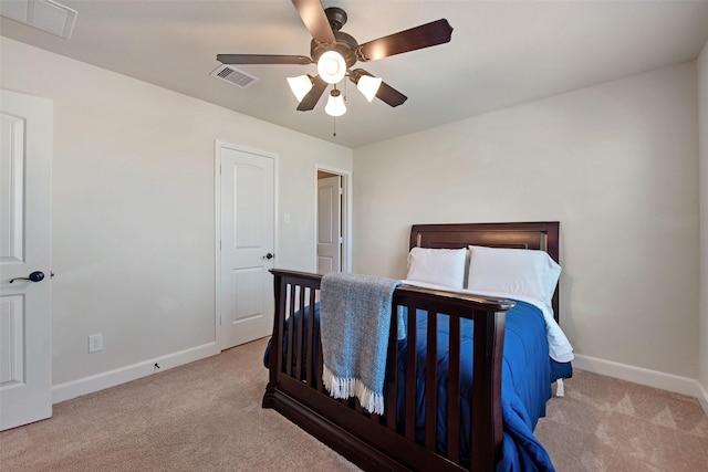 carpeted bedroom with visible vents, ceiling fan, and baseboards