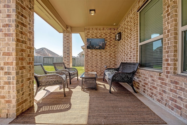 view of patio with an outdoor living space and fence