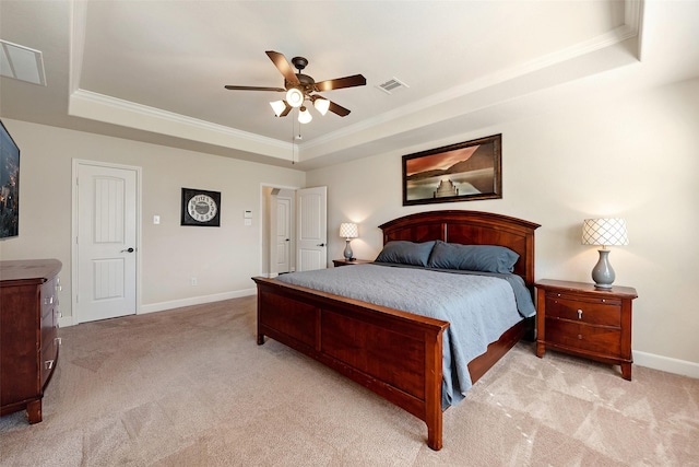 bedroom with a tray ceiling, carpet, visible vents, and baseboards