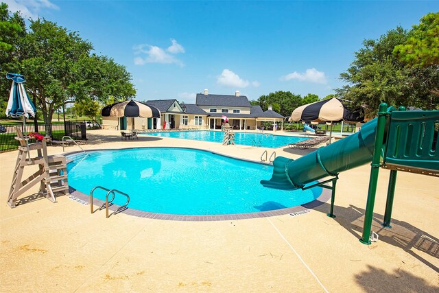 community pool featuring a patio area and fence