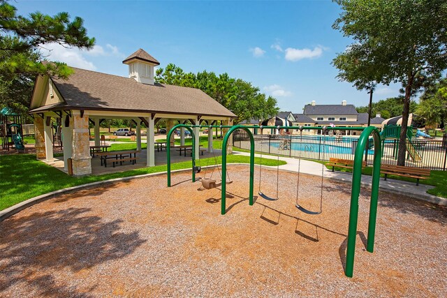 surrounding community with a pool, a gazebo, playground community, and fence