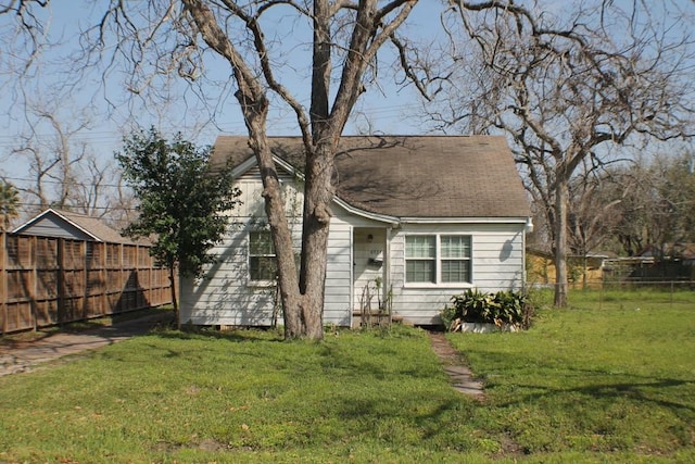 exterior space featuring a front lawn and fence