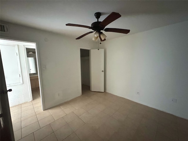 unfurnished bedroom with a closet, visible vents, and ceiling fan