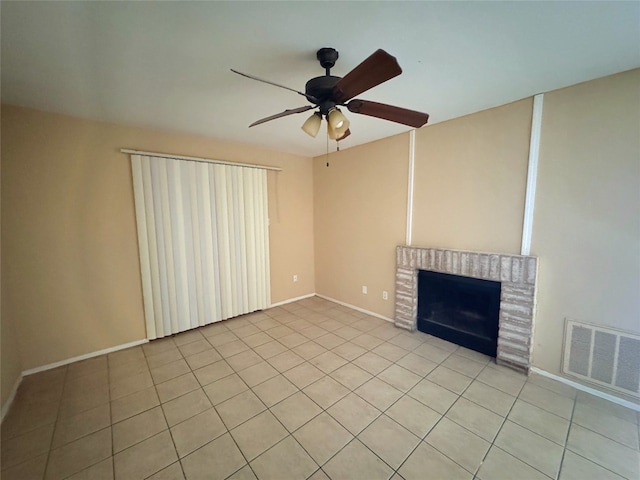 unfurnished living room featuring visible vents, baseboards, a brick fireplace, and ceiling fan