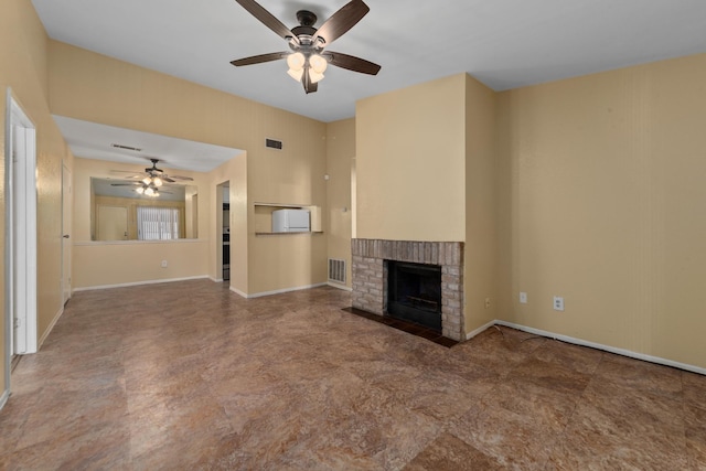 unfurnished living room featuring visible vents, baseboards, a brick fireplace, and a ceiling fan