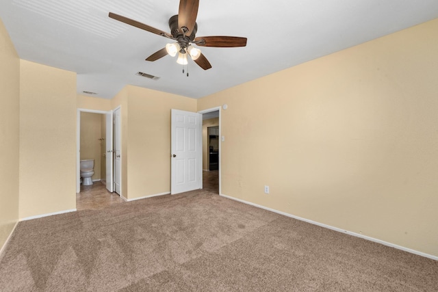 unfurnished bedroom featuring visible vents, carpet floors, and baseboards