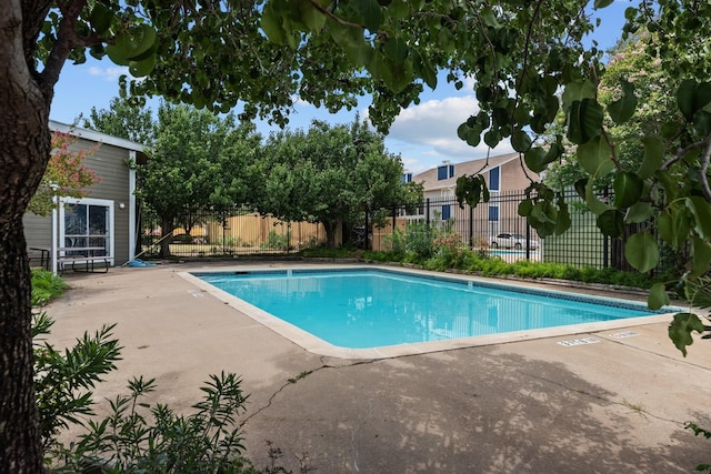 pool featuring a patio area and fence