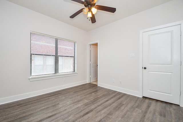 spare room with a ceiling fan, baseboards, and wood finished floors