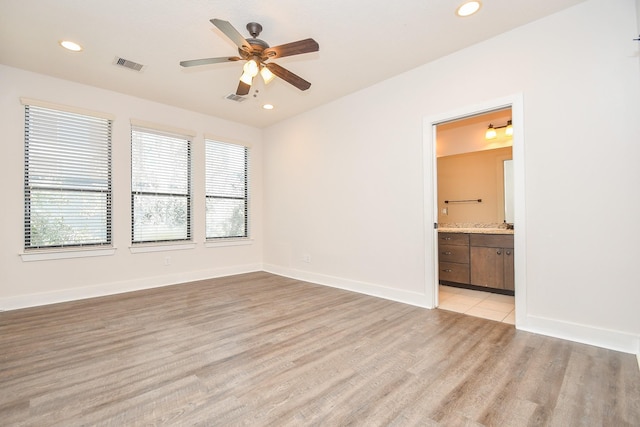 empty room featuring recessed lighting, baseboards, and visible vents