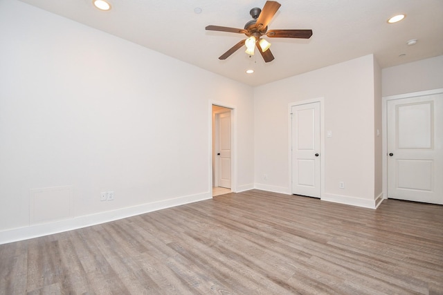 unfurnished room with recessed lighting, baseboards, wood finished floors, and a ceiling fan