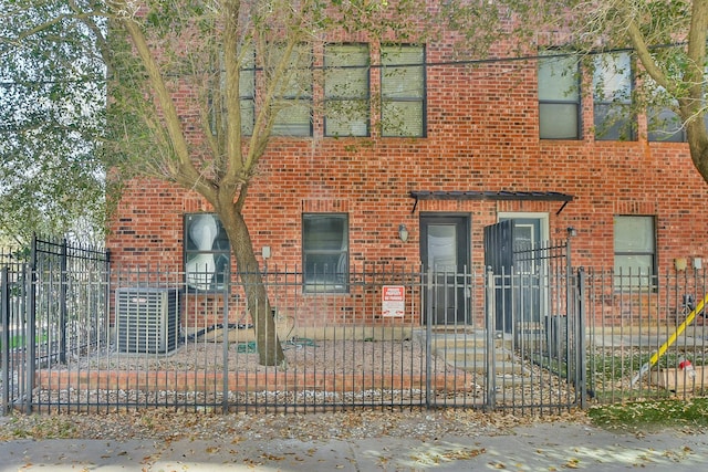 view of front of home with brick siding and a fenced front yard