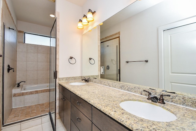 full bath with a sink, a relaxing tiled tub, tile patterned floors, and a tile shower