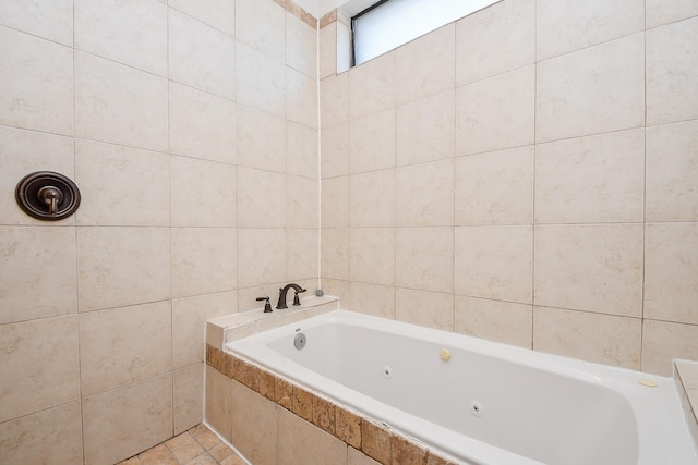 bathroom with tile walls and a whirlpool tub