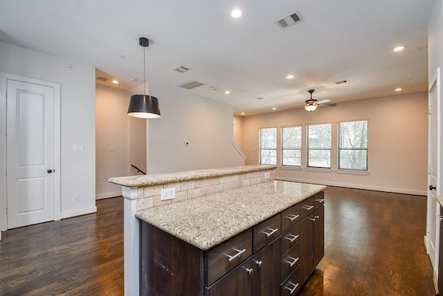 kitchen featuring dark wood finished floors, recessed lighting, and visible vents