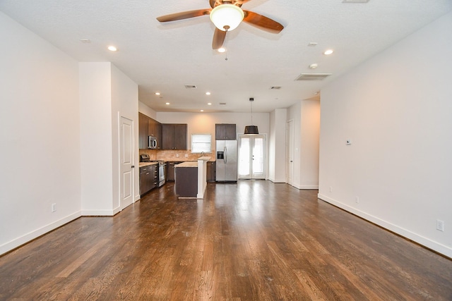 unfurnished living room with baseboards, visible vents, recessed lighting, ceiling fan, and dark wood-type flooring