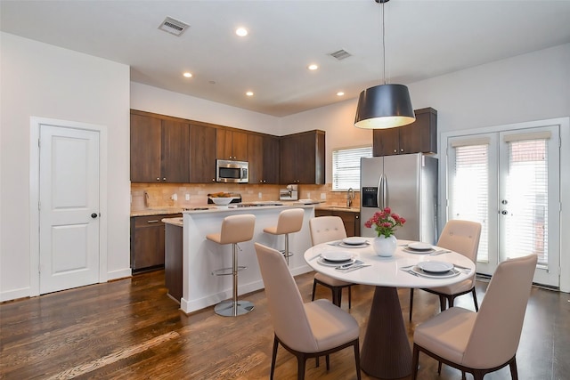 dining room featuring recessed lighting, dark wood-style floors, visible vents, and french doors