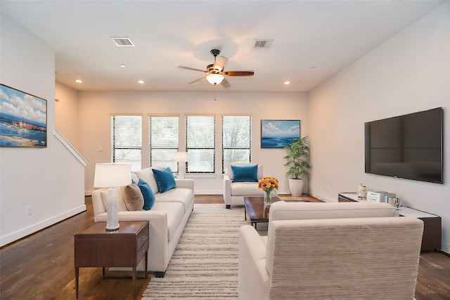 living area featuring recessed lighting, visible vents, and wood finished floors