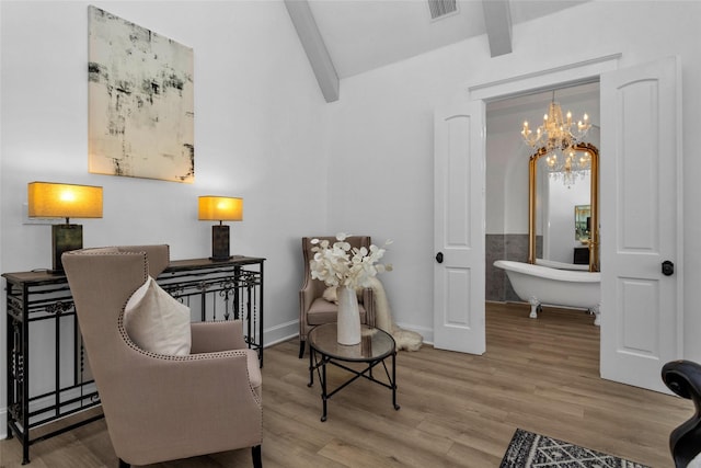 sitting room featuring beamed ceiling, baseboards, visible vents, and wood finished floors