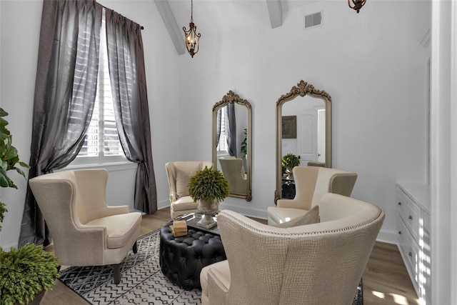 sitting room featuring visible vents, baseboards, and wood finished floors