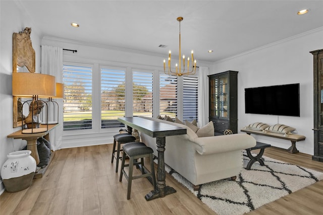 dining space featuring visible vents, crown molding, a chandelier, recessed lighting, and wood finished floors