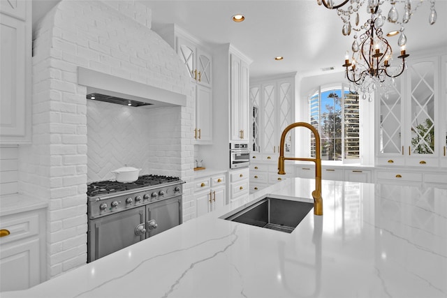 kitchen with white cabinets, tasteful backsplash, and a sink