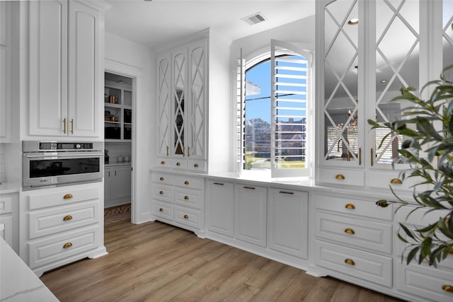 spacious closet featuring visible vents and light wood-type flooring