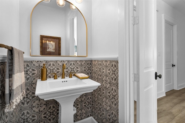 bathroom with wainscoting and tile walls