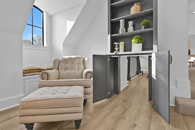 sitting room with light wood-type flooring and baseboards