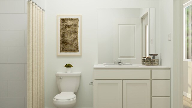 bathroom featuring a shower with shower curtain, toilet, and vanity