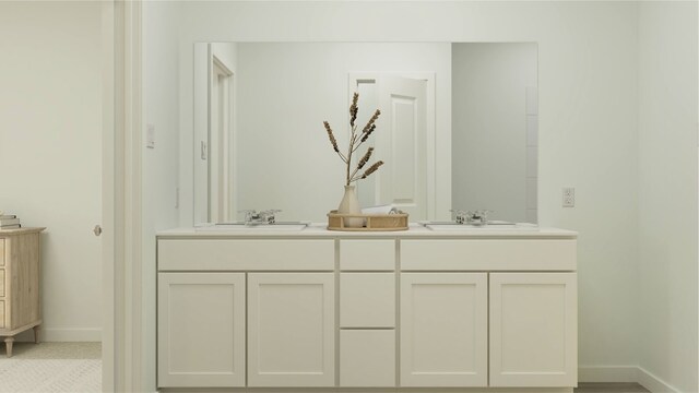 full bath with double vanity, baseboards, and a sink