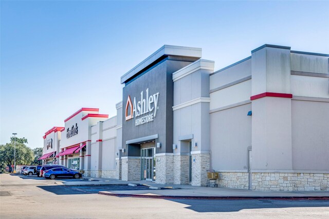 view of building exterior featuring uncovered parking