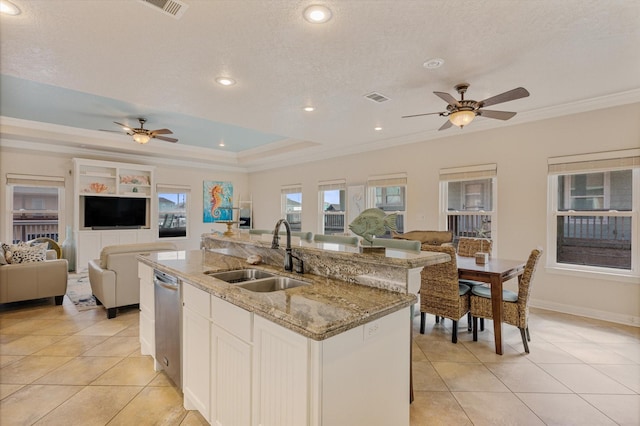 kitchen featuring open floor plan, ceiling fan, and a sink