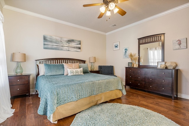 bedroom with visible vents, baseboards, wood finished floors, and ornamental molding