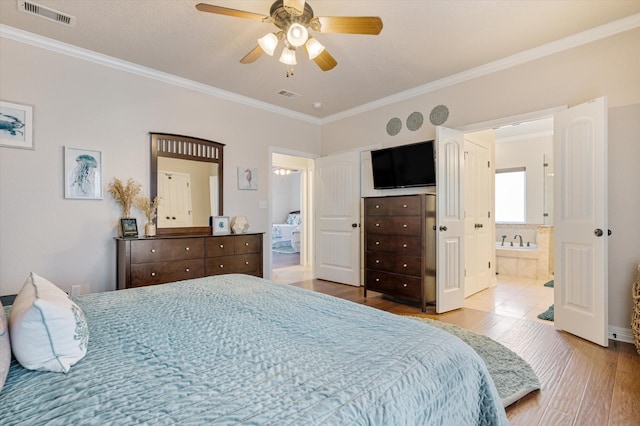 bedroom featuring visible vents, wood finished floors, and crown molding