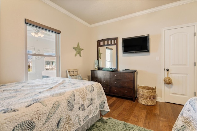 bedroom with wood finished floors, baseboards, and ornamental molding