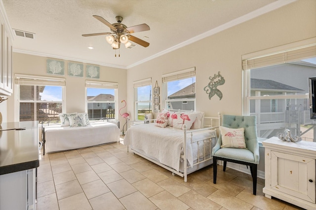 bedroom featuring crown molding, light tile patterned floors, visible vents, and ceiling fan