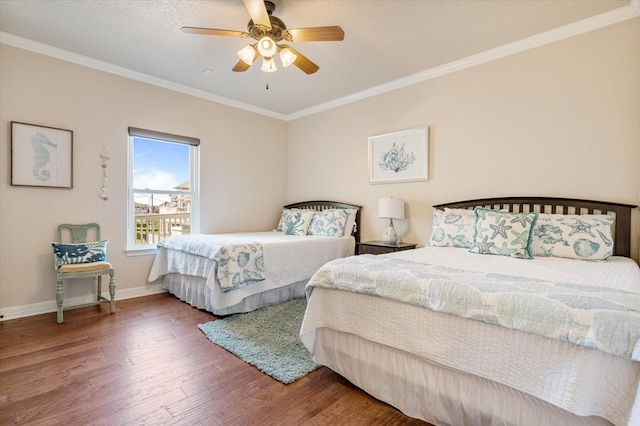 bedroom featuring ceiling fan, baseboards, wood finished floors, and crown molding