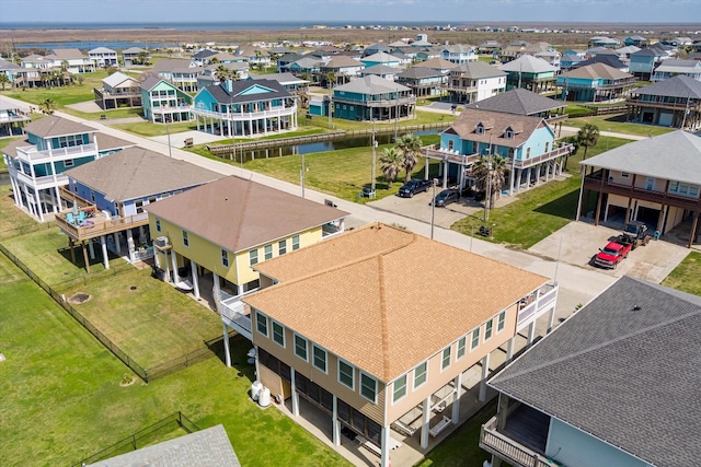 drone / aerial view with a residential view and a water view