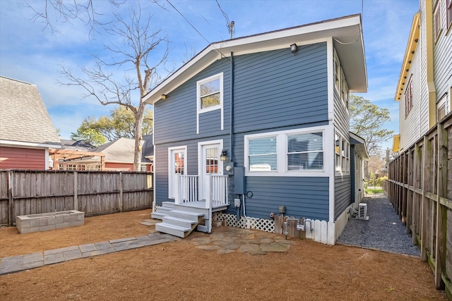 back of property featuring fence