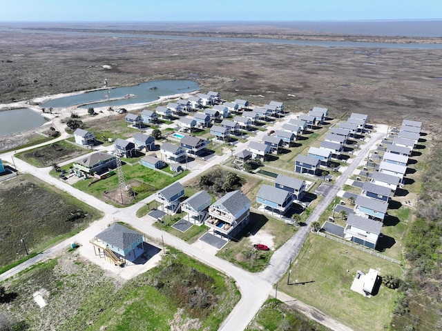 birds eye view of property with a residential view and a water view