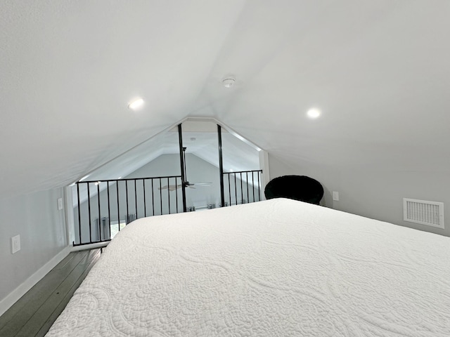 bedroom featuring vaulted ceiling, visible vents, baseboards, and dark wood-style flooring