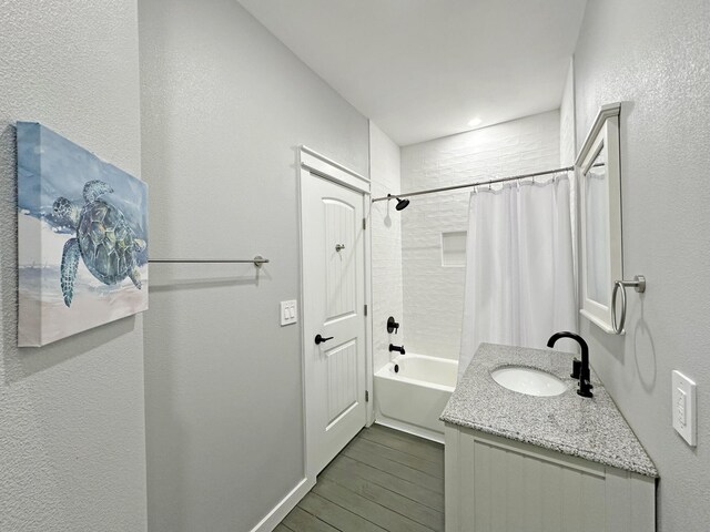1040 Johnson Rd, Gilchrist, TX 77617 - bathroom featuring shower / bath combo, a textured wall, wood finished floors, and vanity