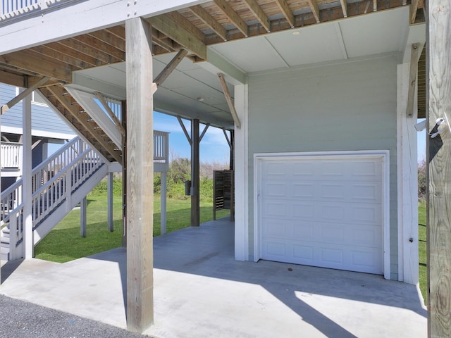 view of patio / terrace featuring a garage and stairs